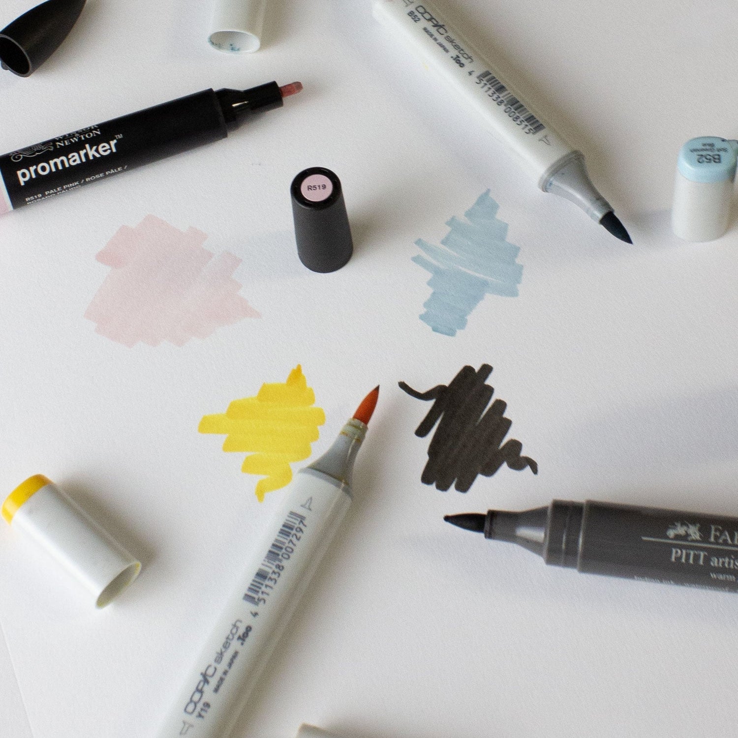 Drawing Supplies layed on paper with scribbles