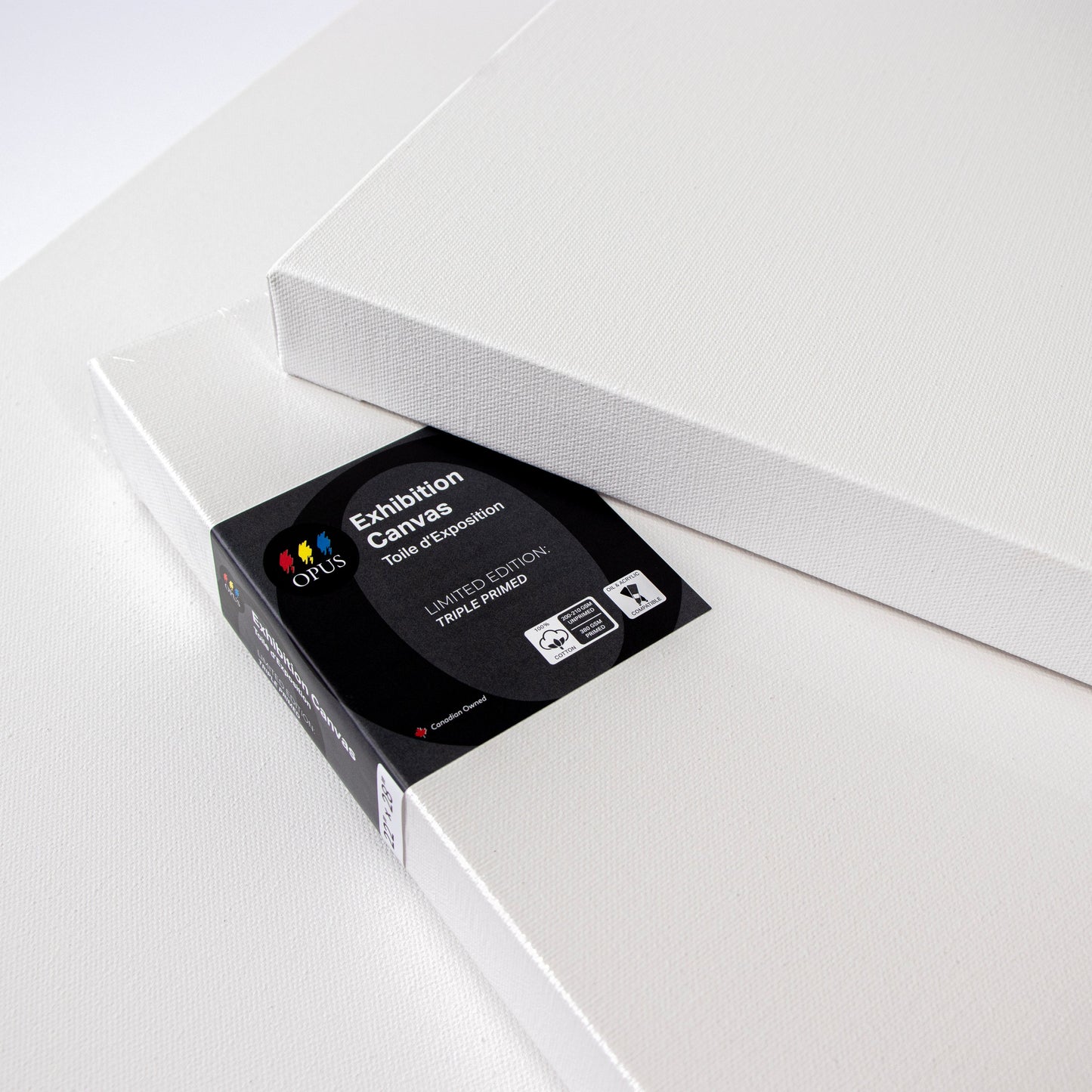 Three Opus Exhibition Limited Edition Canvas Black Label stacked on a table top to show the gesso'd canvas texure