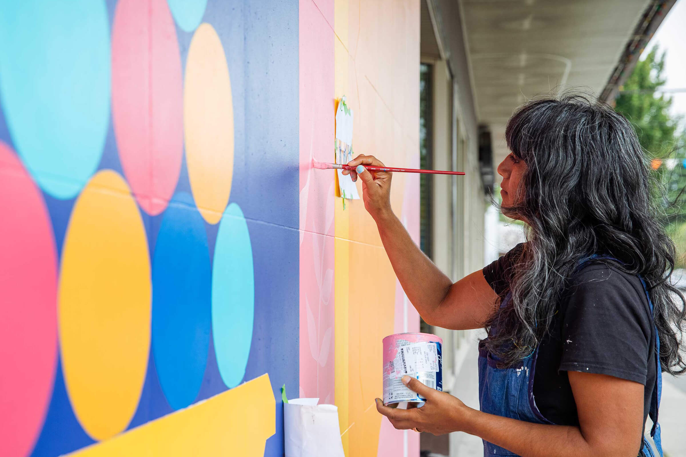 Artist Sandeep Johal working on a mural.