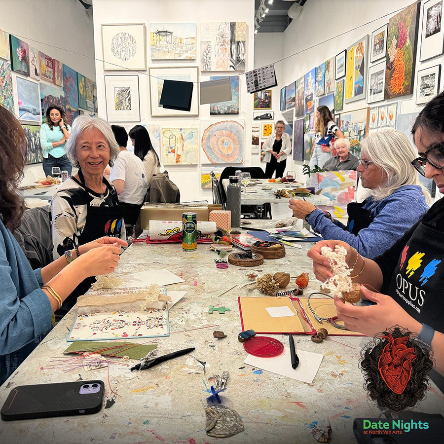 Artists gather around a table making art together at North Van Arts