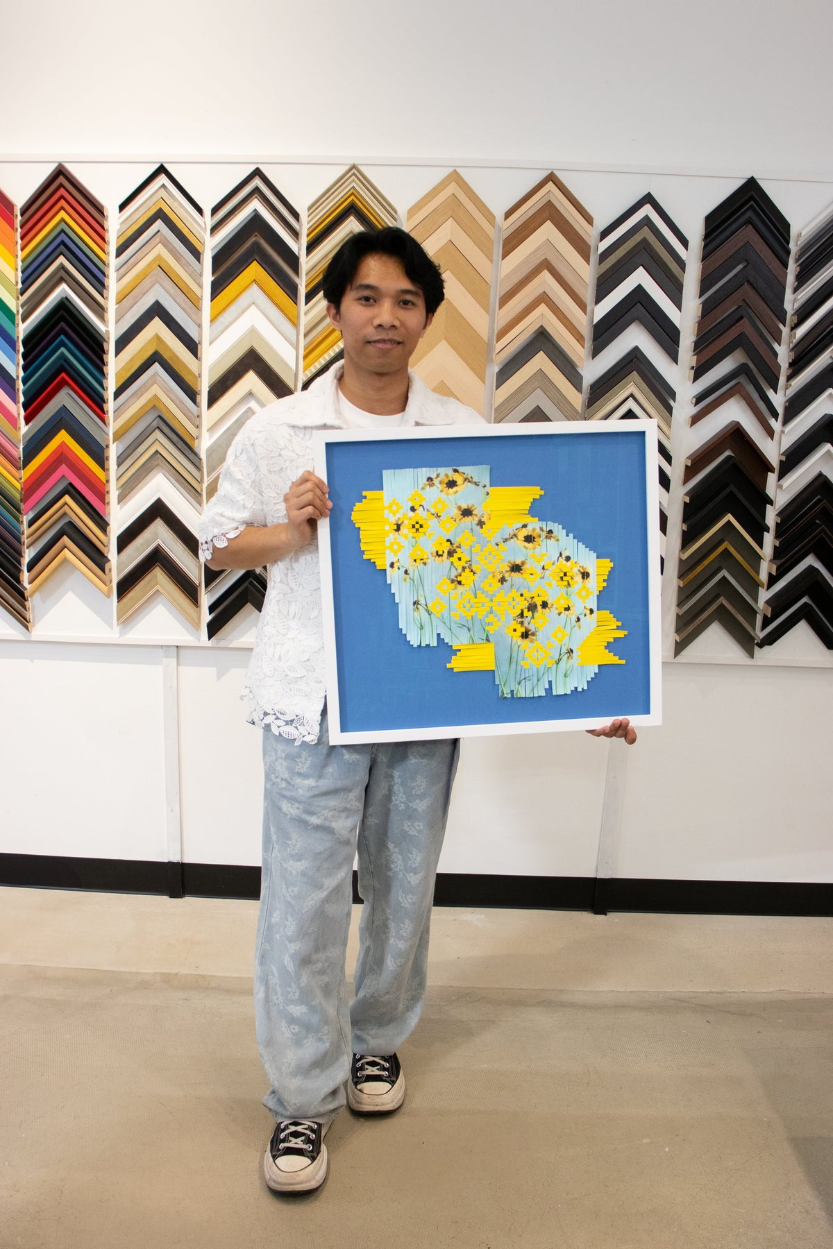 Karl Hipol, artist, showing his work in an Opus Luna Frame