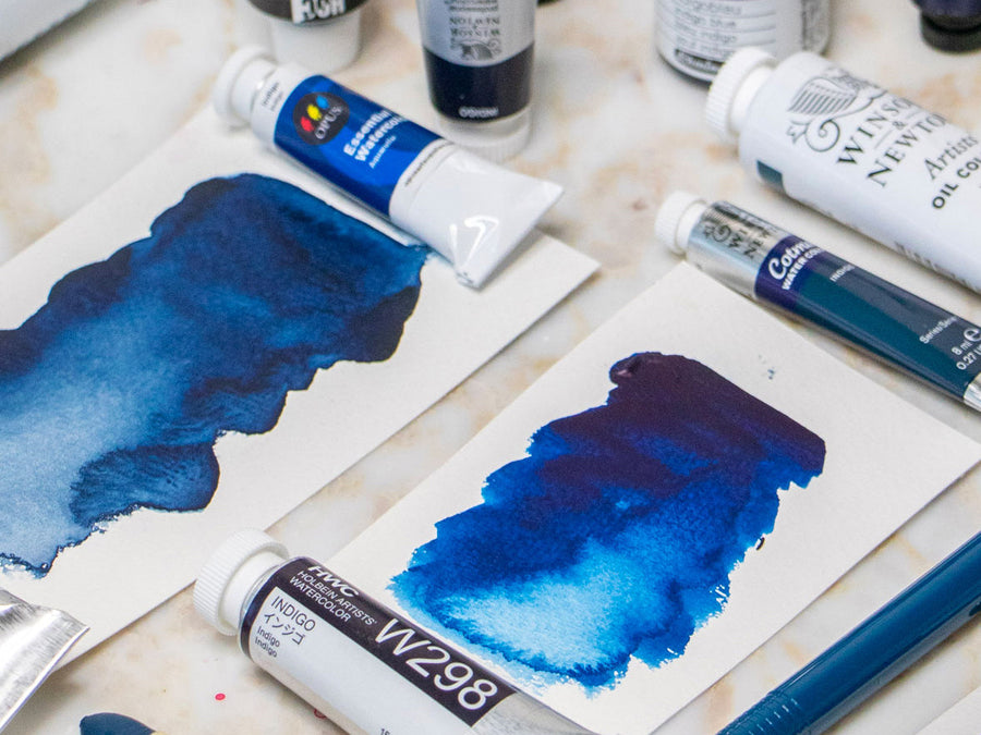 A range of watercolour paints in the colour Indigo with swatches of the colour