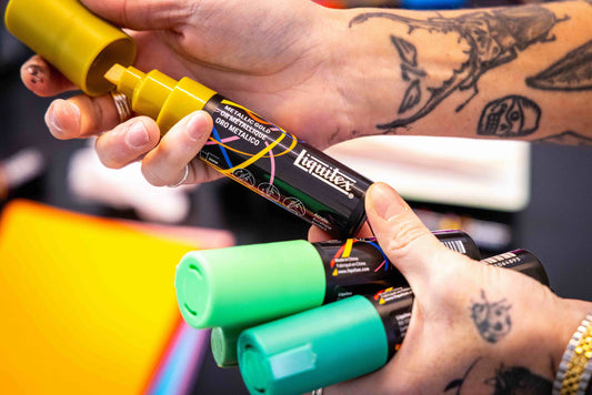 Person  holding acrylic markers 