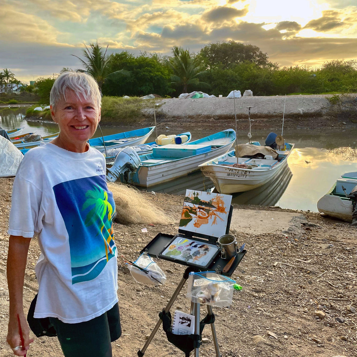 Artist Sheree Jones paints on the edge of a river in Mexico