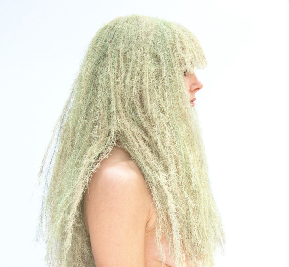 Artist Natasha Lavdovsky wearing a wig made of lichen