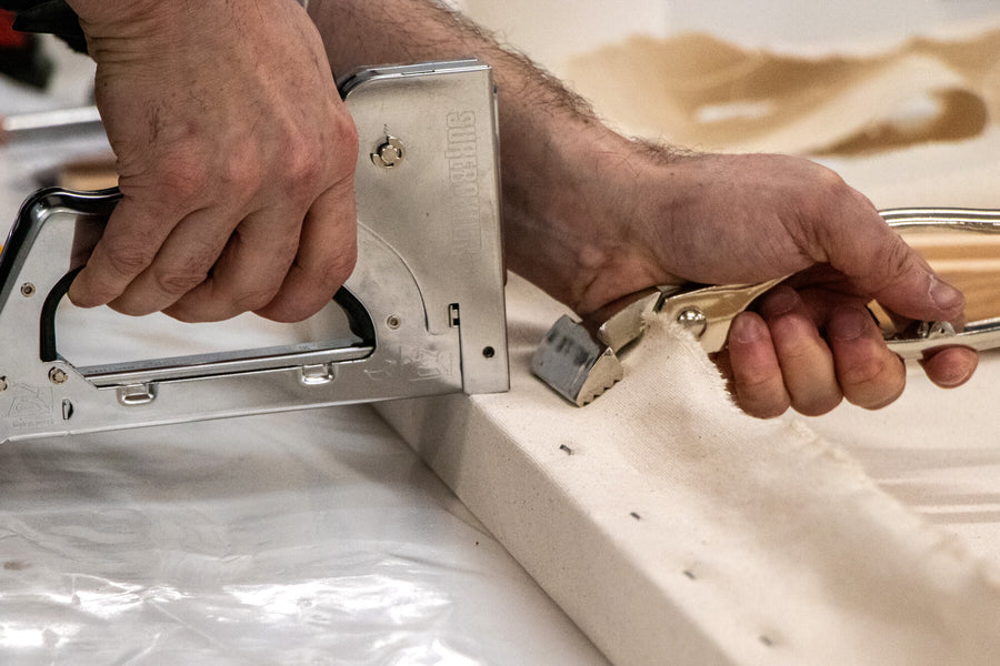 Stapling the corner of an Opus Finest Stretched Canvas