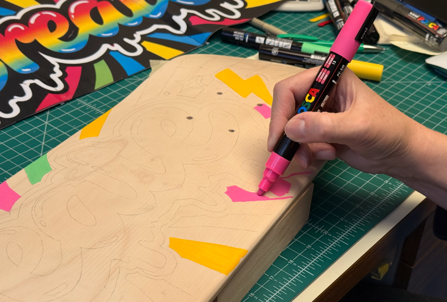 Posca Acrylic Markers being used on a Blank Skateboard Deck