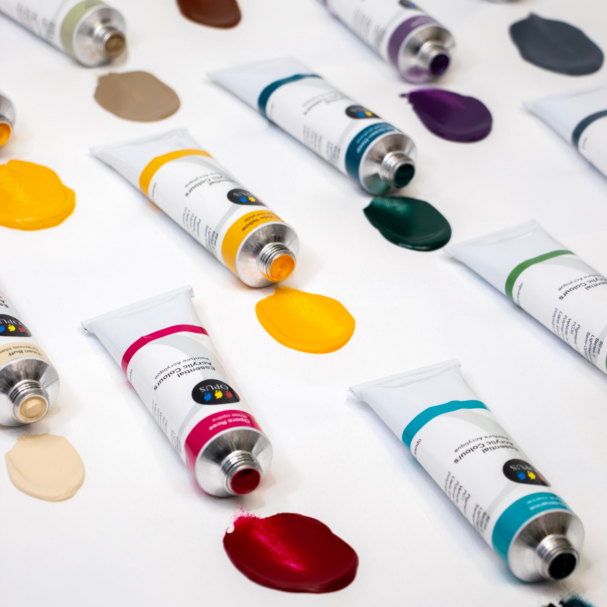 Various tubes of paint with color samples on a white background