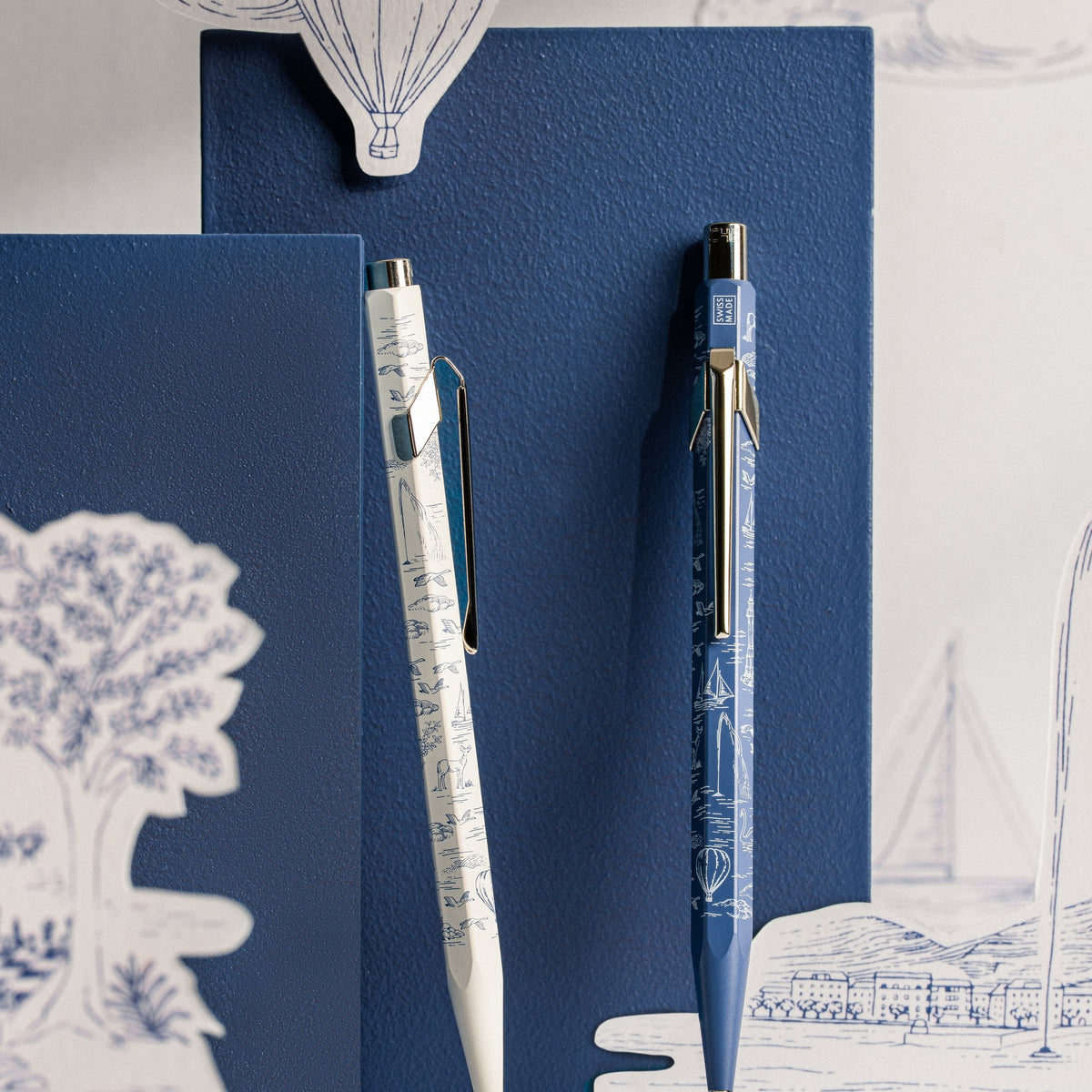 Caran d'Ache Toile de Jouy 849 ballpoint pen and mechanical pencil styled with Geneva paper cut-outs