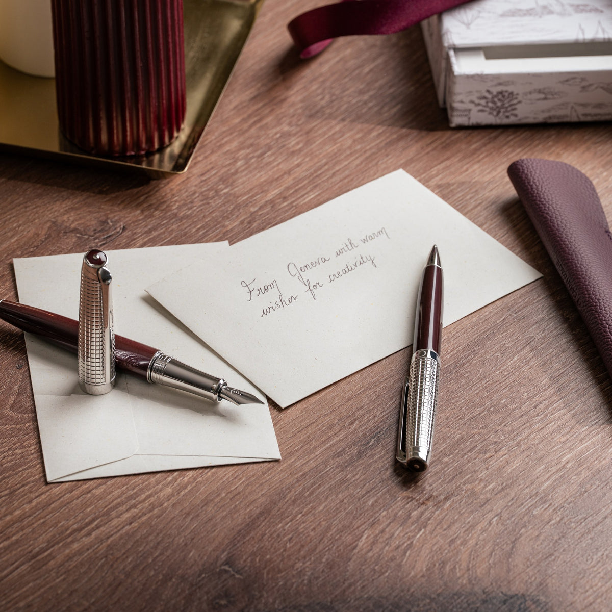 Caran d'Ache Toile de Jouy Léman pens with leather holder on a desk